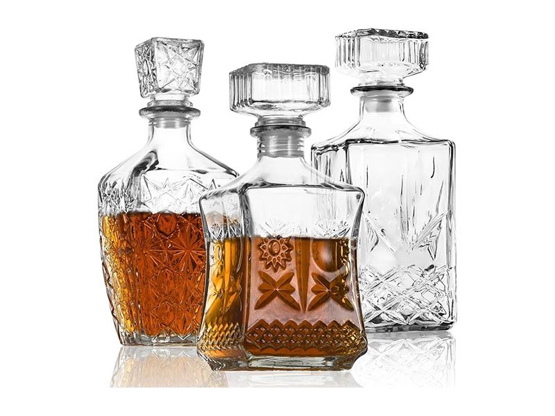 Three elegant glass decanters
