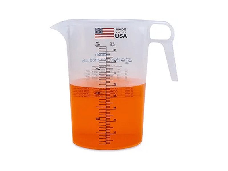 Measuring cup with orange liquid