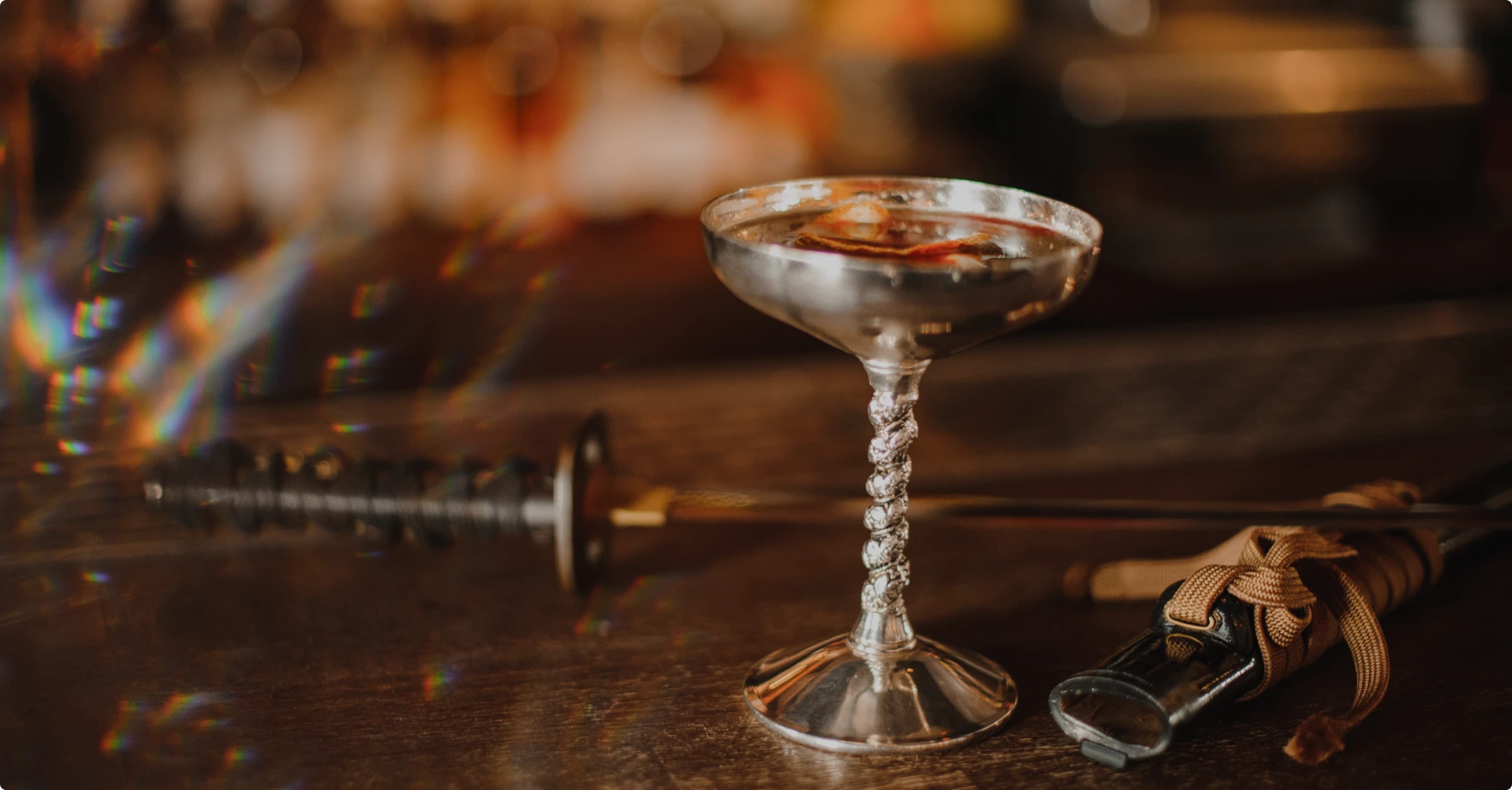 Silver goblet on wooden table with katana